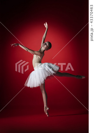 Ballerina. Young graceful female ballet dancer dancing at red studioskill. Beauty of classic ballet. Ballerina. Young graceful female ballet dancer dancing at red studioskill. Beauty of classic ballet. 43370463
