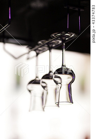 Glasses for a grappa hang over a bar counter Glasses for a grappa hang over a bar counter 43374783