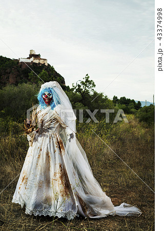 scary evil clown in a bride dress outdoors scary evil clown in a bride dress outdoors 43374998