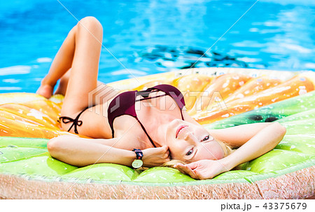 Beautiful model girl lies on shapes air mat 43375679