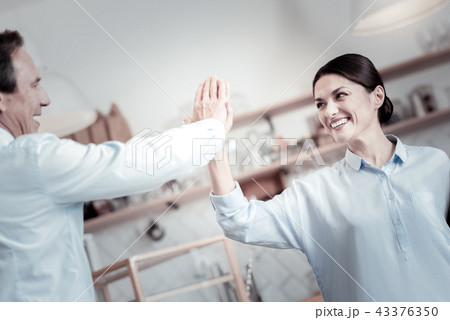 Happy people giving five to each other while being in a cafe 43376350