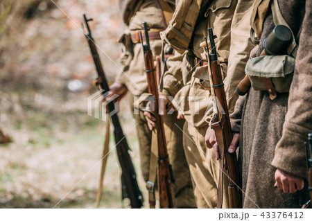 Close Up Of Re-enactors Dressed As Soviet Infantry Soldiers Of World War II Holds Rifles Weapons In Close Up Of Re-enactors Dressed As Soviet Infantry Soldiers Of World War II Holds Rifles Weapons In 43376412