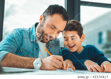 Positive delighted daddy spending time with son Positive delighted daddy spending time with son 43376817