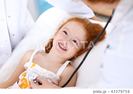 Doctor examining a little girl with stethoscope.Medicine and healthcare concept Doctor examining a little girl with stethoscope.Medicine and healthcare concept 43379758