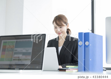 会社で仕事をする若い女性 会社で仕事をする若い女性 43380444