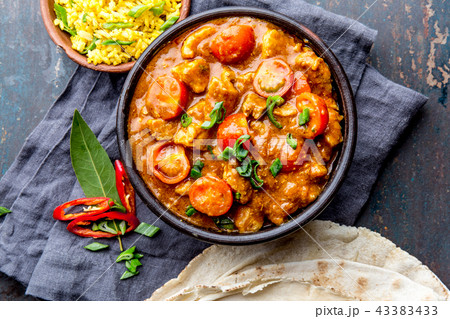 INDIAN FOOD. ROGAN JOSH curry sauce. Pork rogan josh with rice and naan bread INDIAN FOOD. ROGAN JOSH curry sauce. Pork rogan josh with rice and naan bread 43383433