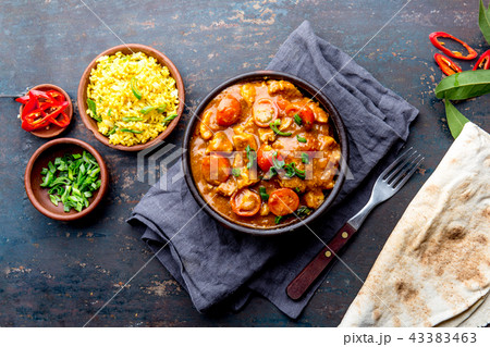 INDIAN FOOD. ROGAN JOSH curry sauce. Pork rogan josh with rice and naan bread 43383463