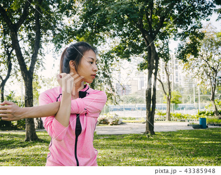 woman warm up her body by stretching her arms. 43385948