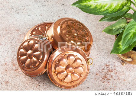Vintage copper molds on a concrete background. 43387185