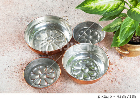 Vintage copper molds on a concrete background. 43387188