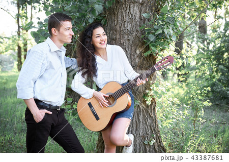 young couple walking in the forest  43387681