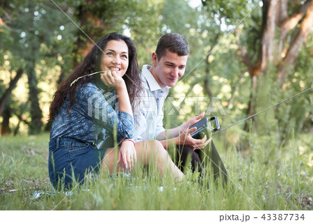 young couple walking in the forest young couple walking in the forest 43387734