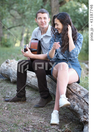 young couple walking in the forest young couple walking in the forest 43387746