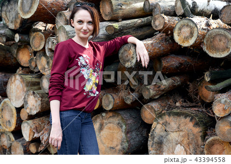 young girl having fun in forest, posing near logs young girl having fun in forest, posing near logs 43394558