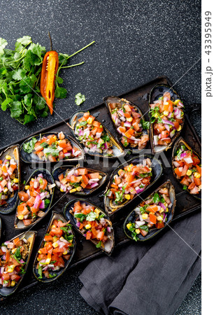 PERUVIAN FOOD. Choros a la chalaca. Big mussels, choros zapatos seasoned with purple onion, tomatoes 43395949