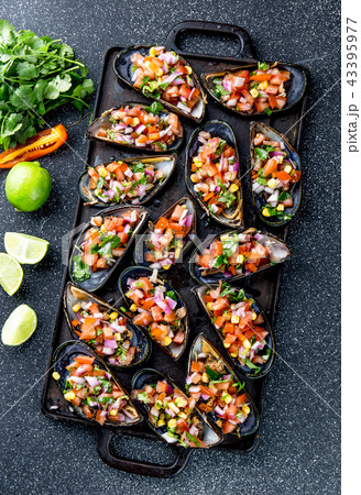 PERUVIAN FOOD. Choros a la chalaca. Big mussels, choros zapatos seasoned with purple onion, tomatoes 43395977