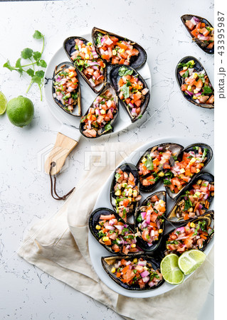 PERUVIAN FOOD. Choros a la chalaca. Big mussels, choros zapatos seasoned with purple onion, tomatoes 43395987