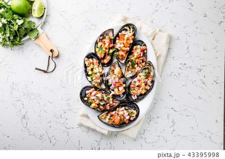 PERUVIAN FOOD. Choros a la chalaca. Big mussels, choros zapatos seasoned with purple onion, tomatoes 43395998