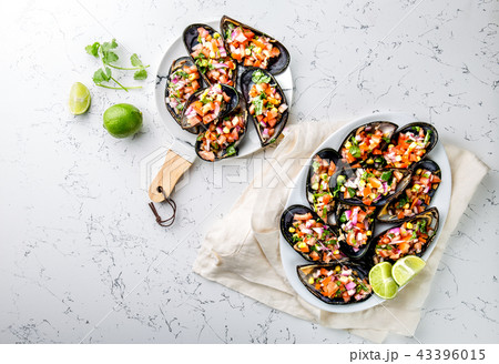 PERUVIAN FOOD. Choros a la chalaca. Big mussels, choros zapatos seasoned with purple onion, tomatoes 43396015