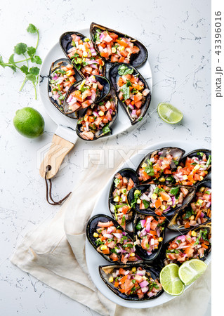 PERUVIAN FOOD. Choros a la chalaca. Big mussels, choros zapatos seasoned with purple onion, tomatoes 43396016