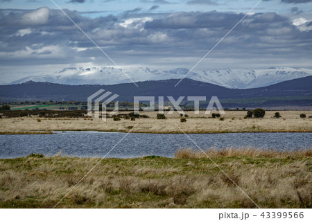 Lake and different levels of mountains with clouds 43399566