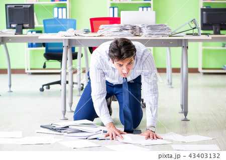 Frustrated businessman stressed from excessive work Frustrated businessman stressed from excessive work 43403132