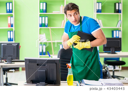 Male spy under cleaner cover stealing confidential documents 43403443