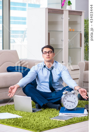 Businessman taking work home and working overtime 43403444