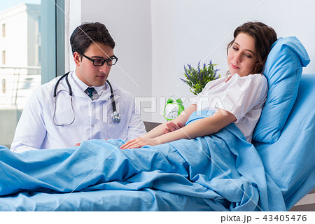 Doctor doing medical injection in hospital room 43405476