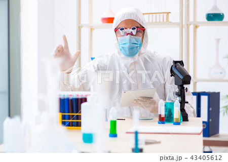 Young chemist student working in lab on chemicals Young chemist student working in lab on chemicals 43405612