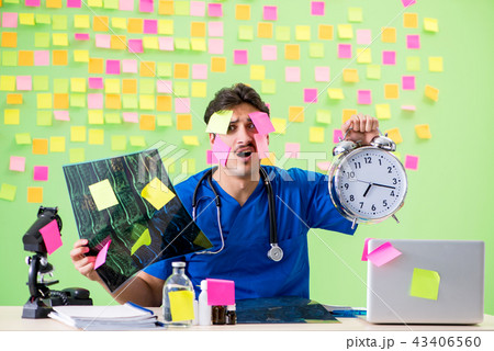 Young doctor with many reminders and urgent work 43406560