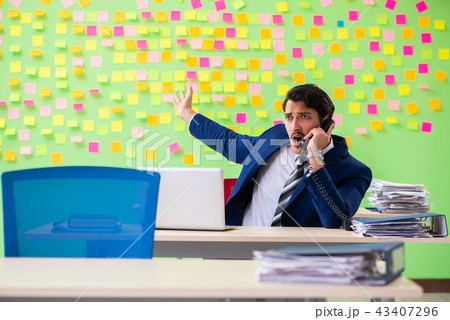 Businessman with many conflicting priorities    43407296