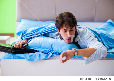 Employee in the bedroom being late for his job  43408216