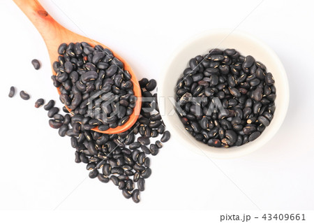 black beans with wooden spoon and in cup on white 43409661