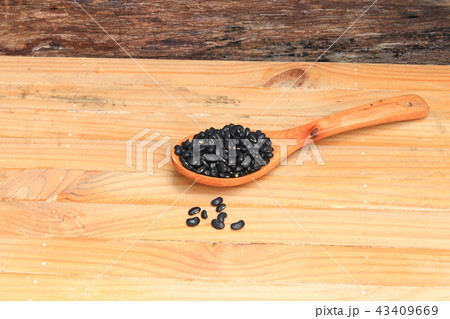 black beans in wooden spoon on wood background black beans in wooden spoon on wood background 43409669