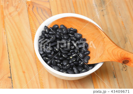 black beans with wooden spoon in bowl black beans with wooden spoon in bowl 43409671