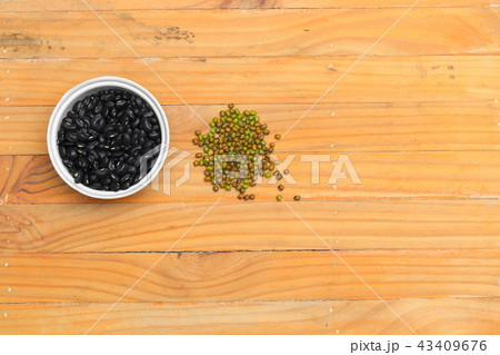 black beans in bowl and green closeup on wood black beans in bowl and green closeup on wood 43409676