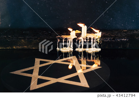 Candle burned wooden table and the Star of David,  43412794
