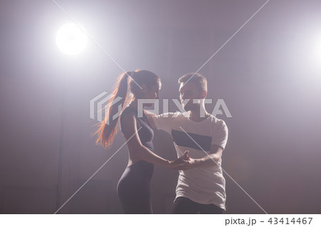 Young couple dancing latin dance Bachata, merengue, salsa. Two elegance pose in dance class 43414467