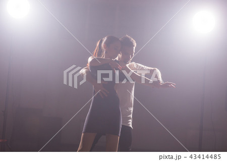 Young couple dancing social danse kizomba or bachata or semba or taraxia in dancing class background Young couple dancing social danse kizomba or bachata or semba or taraxia in dancing class background 43414485