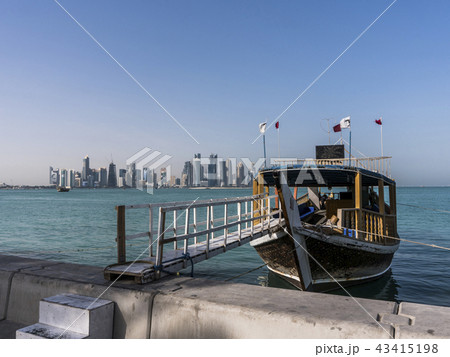 Ladder from Corniche Broadway on Traditional Wooden Boat invite to Gulf City tourist Tour. Beautiful 43415198