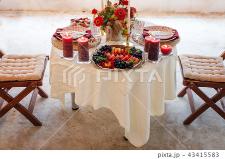 Luxury table settings for fine dining with candles and glassware, beautiful blurred background. For Luxury table settings for fine dining with candles and glassware, beautiful blurred background. For 43415583