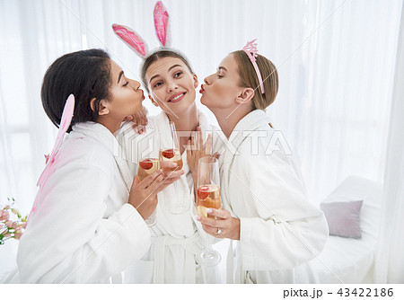 Lovely girls kissing smiling young lady with bunny ears Lovely girls kissing smiling young lady with bunny ears 43422186