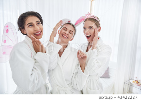 Smiling girls in bathrobes making funny faces 43422227