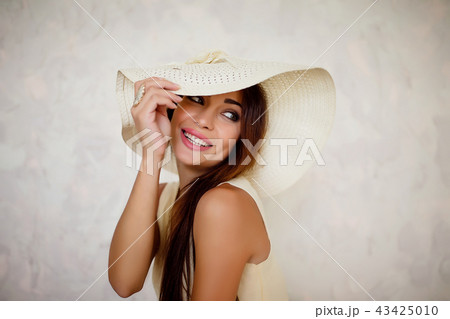 Attractive smiling woman in white sundown Attractive smiling woman in white sundown 43425010