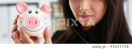 woman hold piggybank in arms 43425756