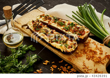 casserole of aubergine cheese and jalapeno peppers on a black table casserole of aubergine cheese and jalapeno peppers on a black table 43426391