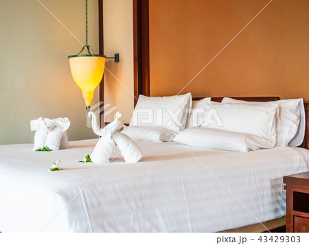 White elephant towel and comfortable pillow on bed White elephant towel and comfortable pillow on bed 43429303