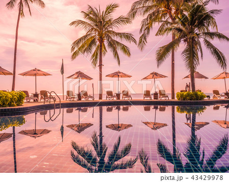 Umbrella and chair around luxury outdoor swimming pool 43429978