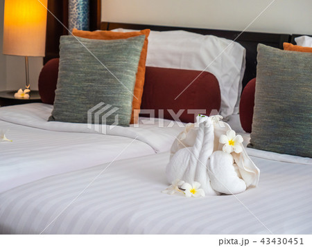 White elephant towel and comfortable pillow on bed 43430451